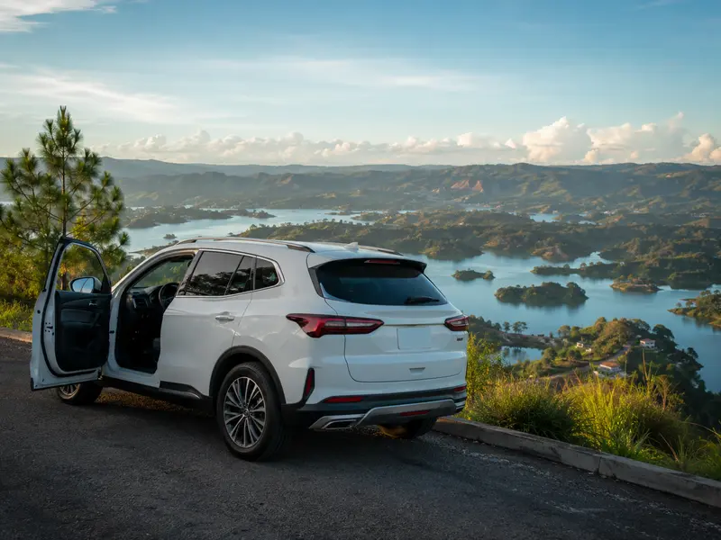 Private tour vehicle at a scenic overlook above the Guatapé reservoir